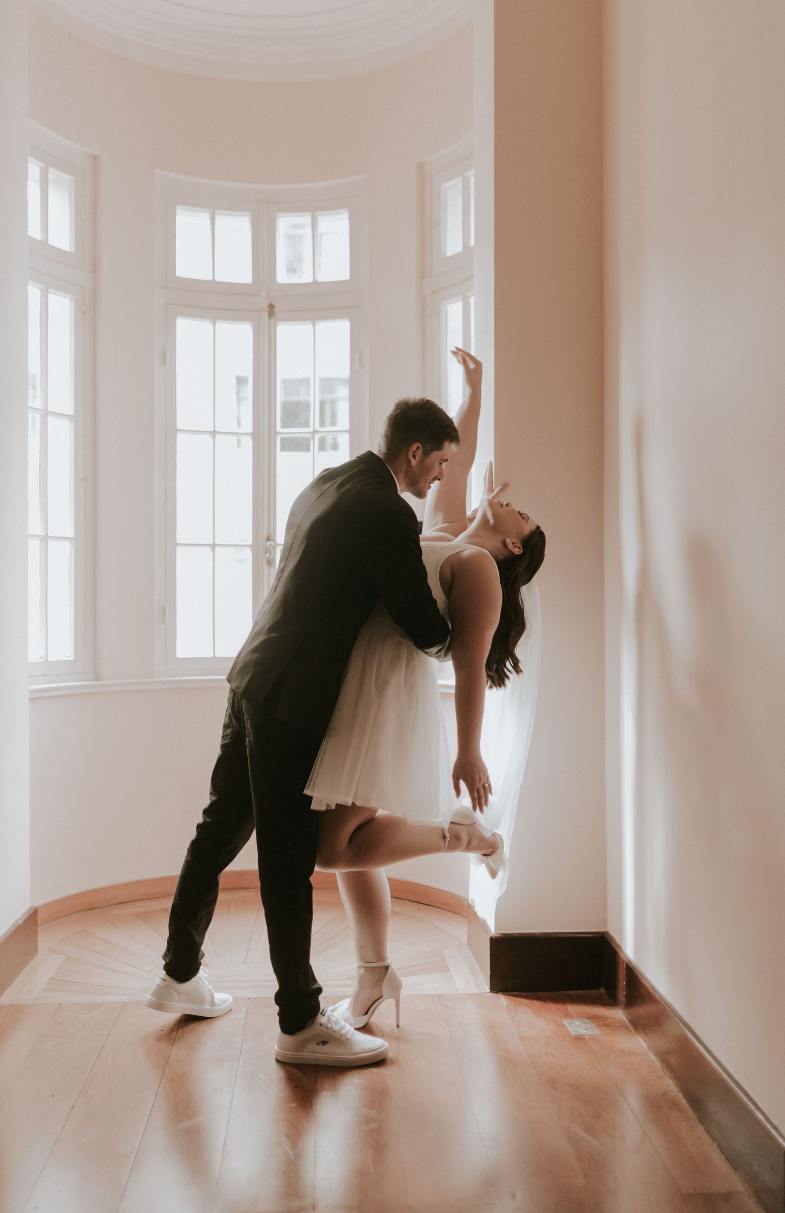 Couple enjoying wedding dance lessons in a sunlit studio